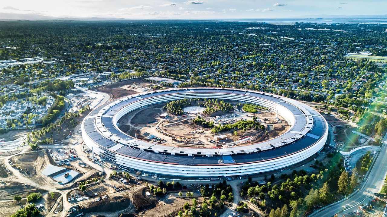 Aerial view of a circular Silicon Valley tech campus surrounded by trees